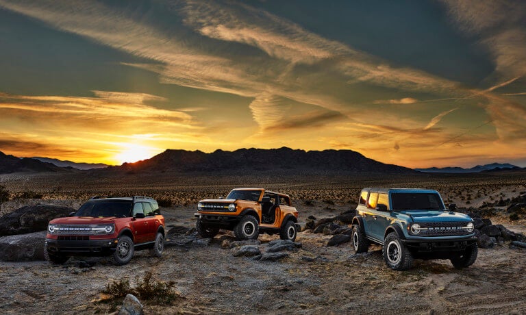 Three 2024 Ford Broncos parked in desert